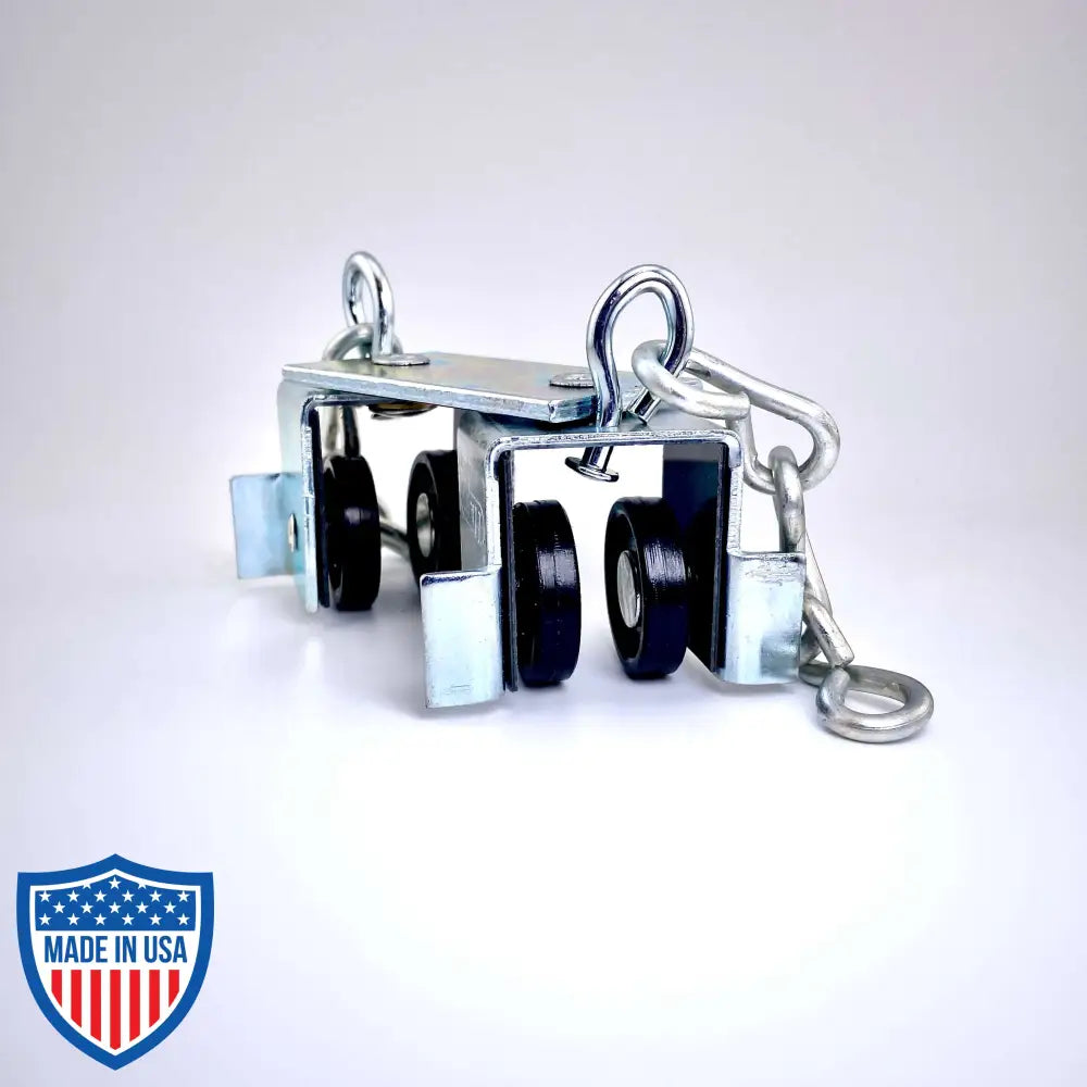 Steel curtain track master carrier with Delrin wheel assemblies, swivel hooks, and trim chains for film grip rigging.