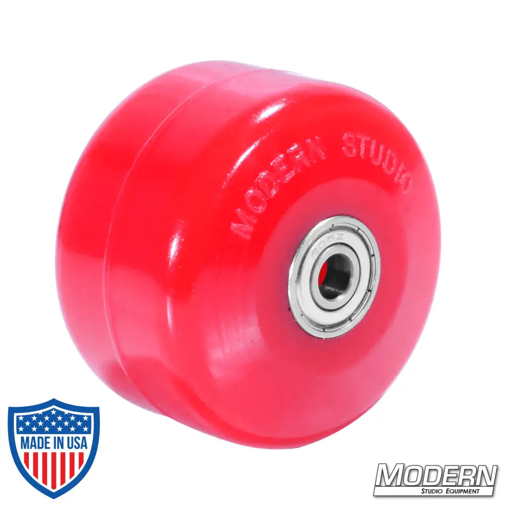 Red skateboard wheel with bearings, ideal for film grip and rigging, by Modern Studio Equipment