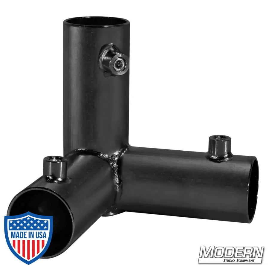Black zinc 3-way pass through corner fitting for 1-1/4-inch Speed-Rail® with set screws used in film grip rigging.