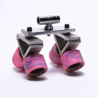 Doorway dolly skateboard wheels with pink grip, used for rigging in film production.