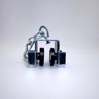 Curtain Track Carrier H&H with Delrin wheels, steel body, swivel hook, and trim chain, ideal for film grip rigging setups.