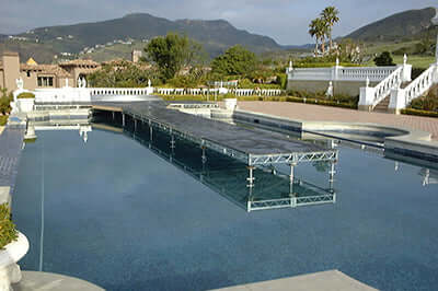 Steel deck platform over a pool with scenic mountain view in the background. Ideal for film grip and rigging needs.