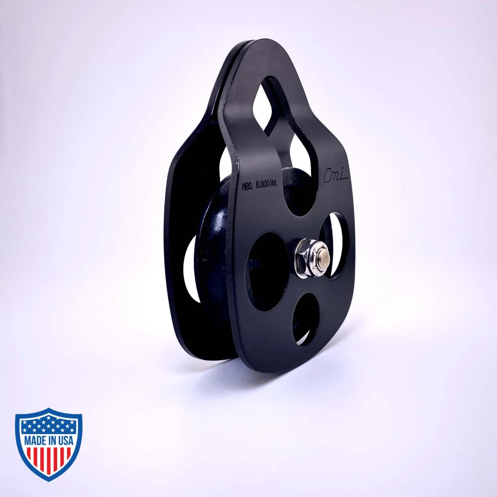 Black Film Pulley CMI RP101FS with anodized aluminum sideplates and stainless steel axle for grip and rigging use in films.