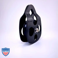 Black Film Pulley CMI RP101FS with anodized aluminum sideplates and stainless steel axle for grip and rigging use in films.