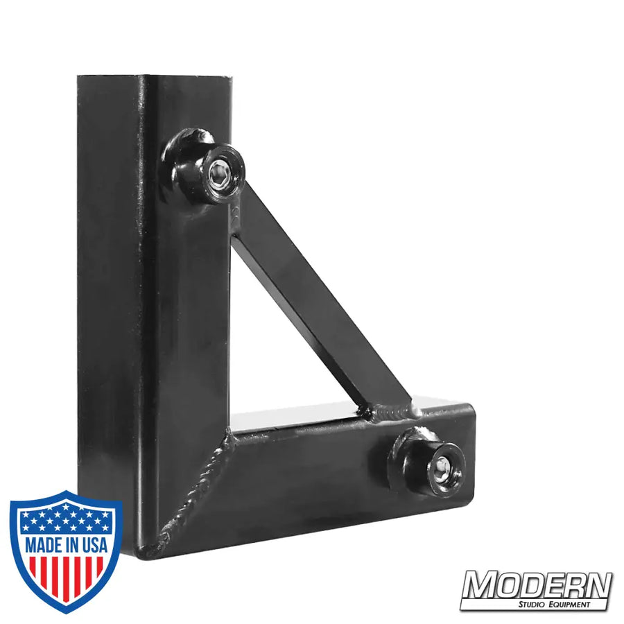 Black zinc corner fitting with set screws for 1-inch square tube, used in film grip and rigging for creating 90º frame corners.