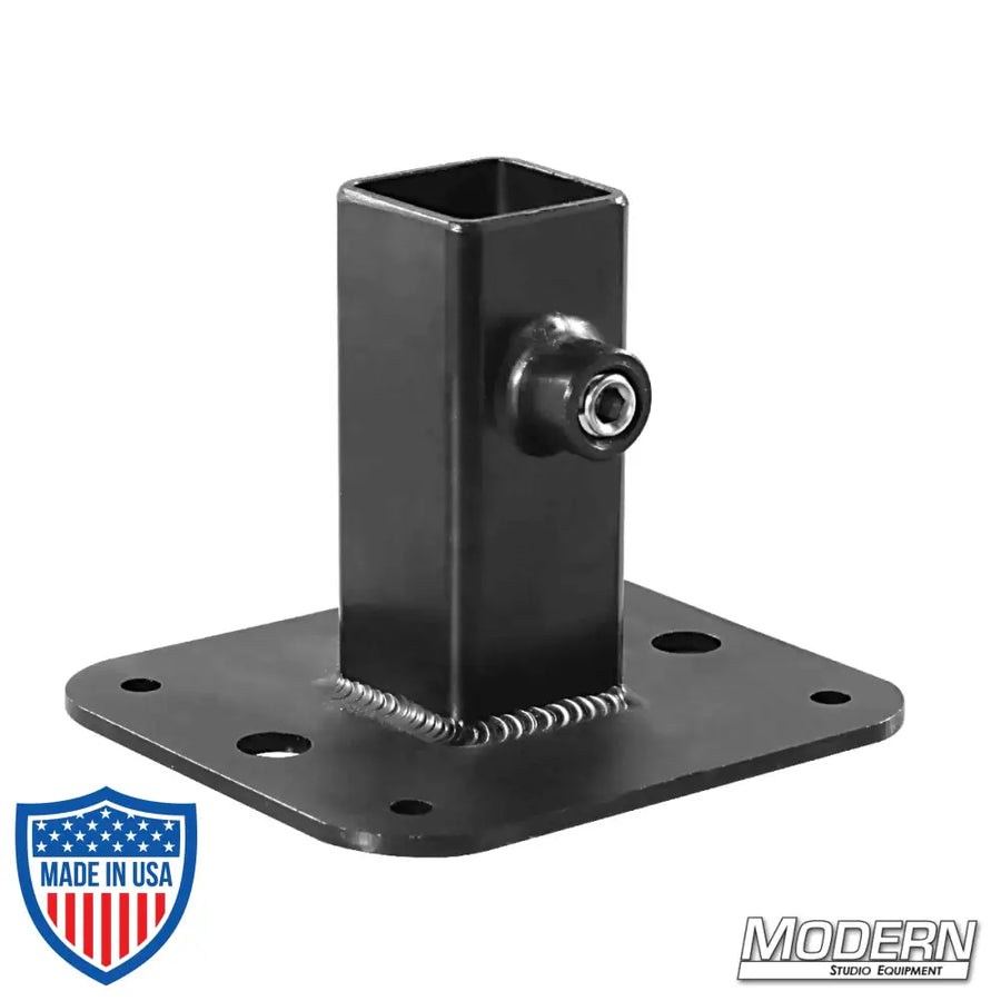 Black zinc flange base for 1-inch square tube with set screws, used in film grip and rigging to add strength and support to frames.