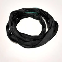 Black GAC Flex spanset with green ID tag for film grip rigging made of Galvanized Aircraft Cable, coiled and displayed on white background.