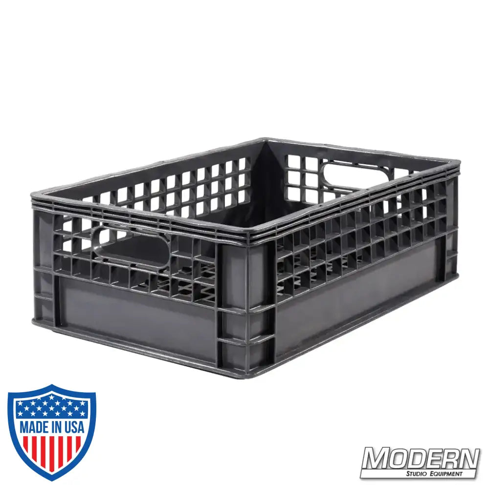 Industry grade plastic half milk crate for film grip and rigging, 19" x 13" x 6.5", stackable with a clean grid bottom.