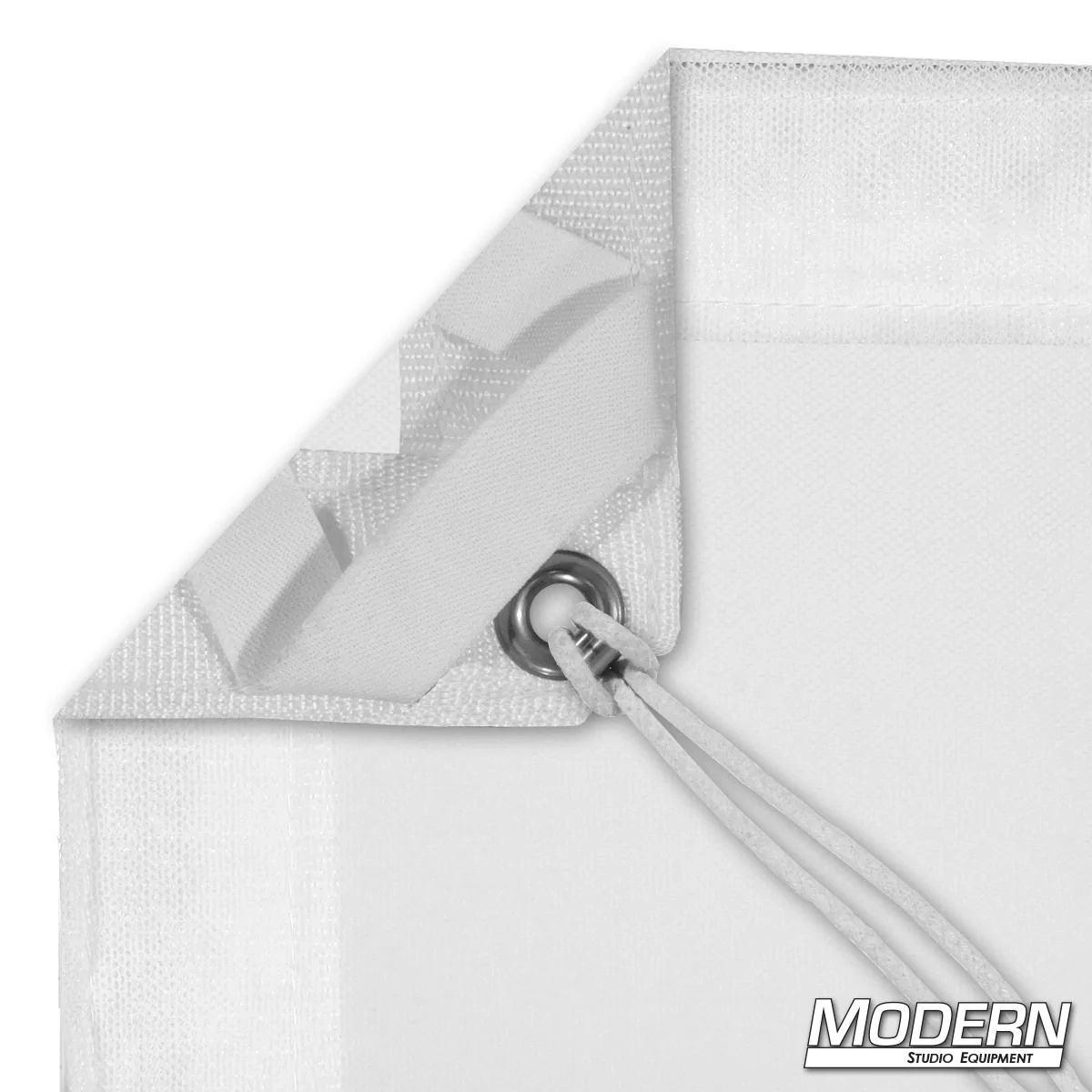 White single scrim with elastic corner and grommet for film grip rigging, includes storage bag for light reduction without altering color.