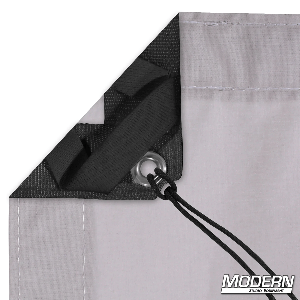 Close-up of Night Gray Muslin corner with webbing, grommet, and tie, ideal for film grip and rigging, provided by Modern Studio Equipment.