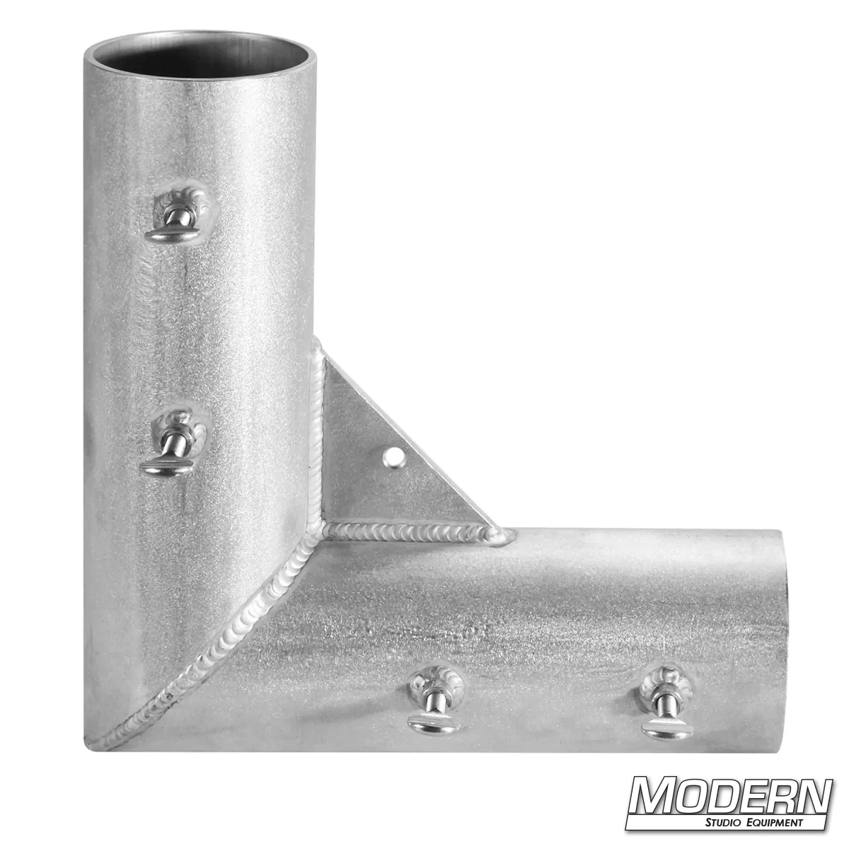 Welded aluminum corner fitting for 4-inch irrigation pipe, used in film grip rigging setups for creating 90º frame angles.