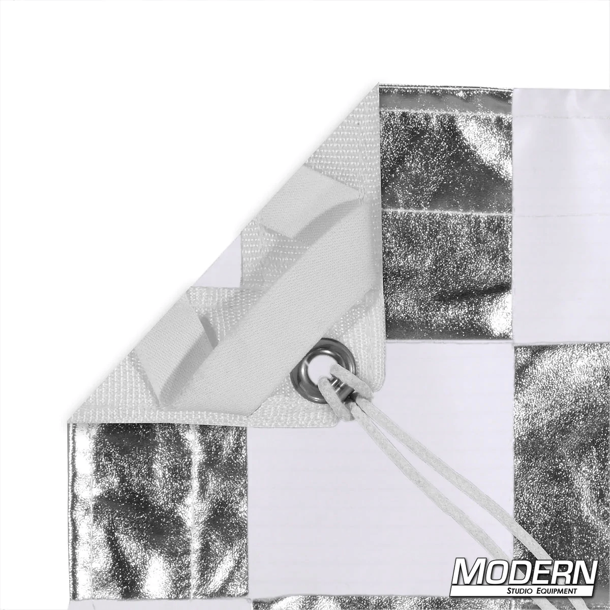 Silver and white checker pattern textile with grommet and ties for film grip rigging, featuring Modern Studio Equipment logo.