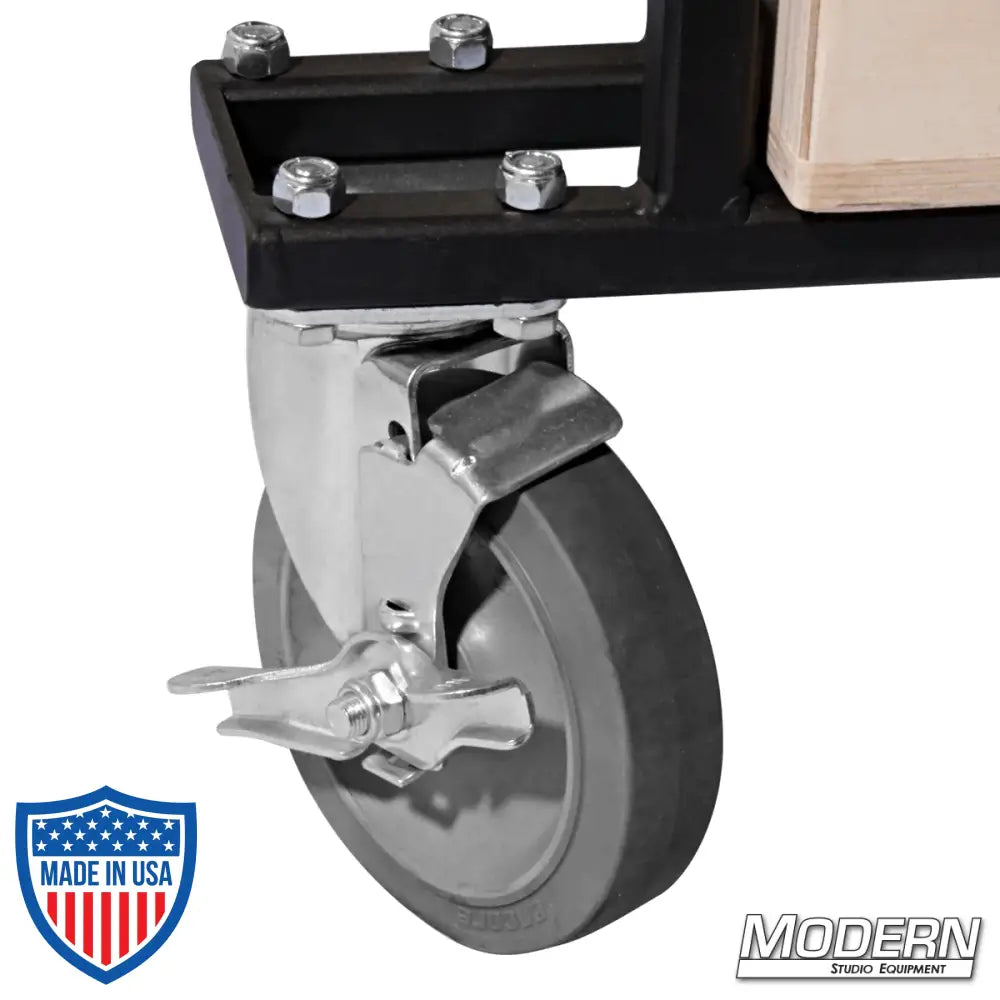 Close-up of front swivel caster with locking brake on Large Grip Cart for film grip and rigging equipment.