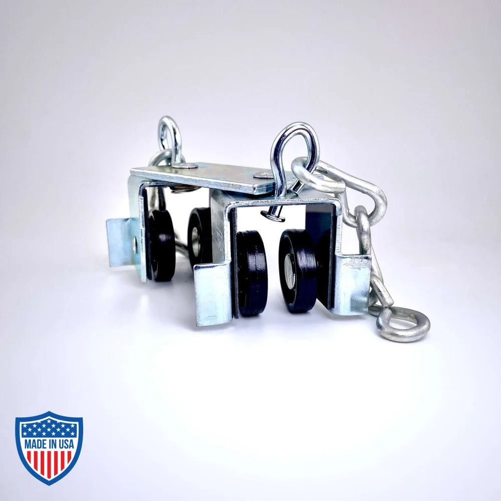 Steel curtain track master carrier with Delrin wheel assemblies, swivel hooks, and trim chains for film grip rigging.