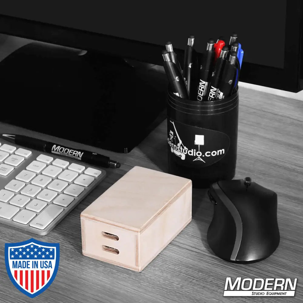 Micro Apple Box on a desk with keyboard, mouse, and pen holder, ideal for film grip and rigging setups.