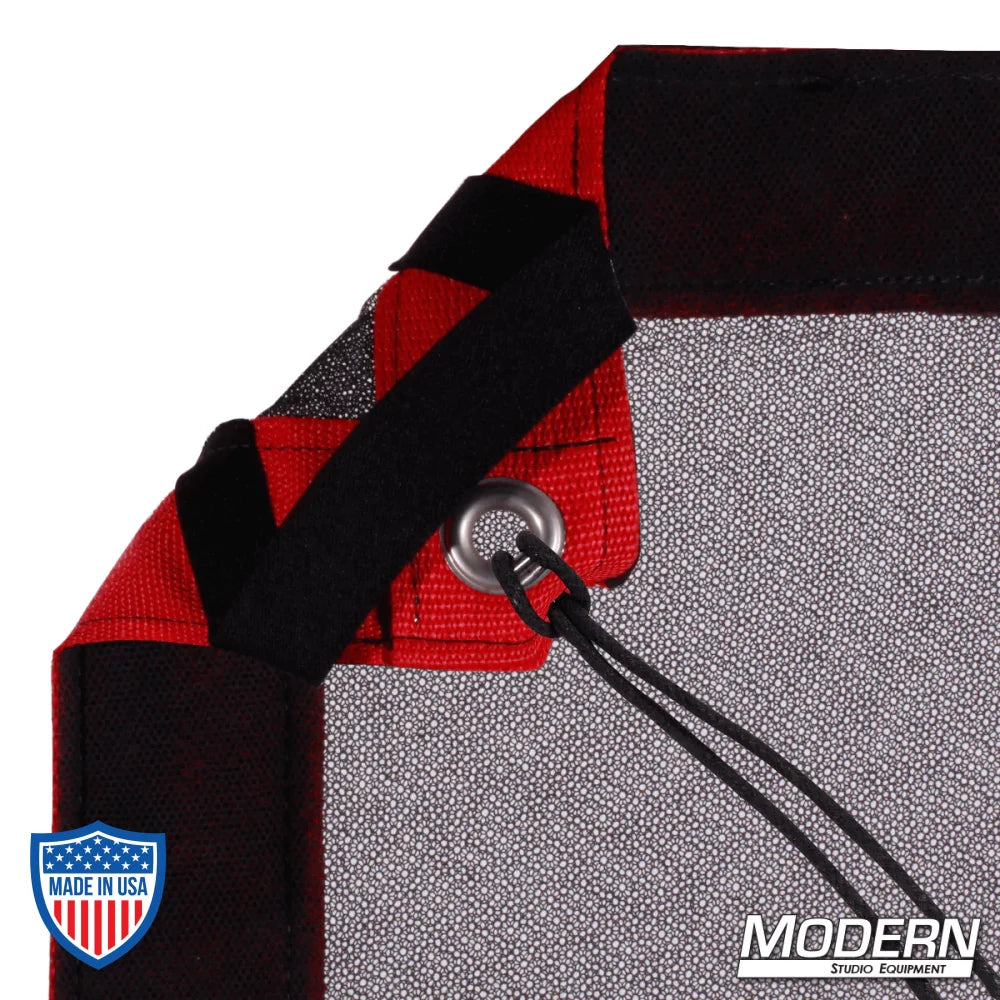Corner detail of Black Double Scrim with webbing, grommets, and ties, featuring elastic for easy rigging. Ideal for film grip setups.