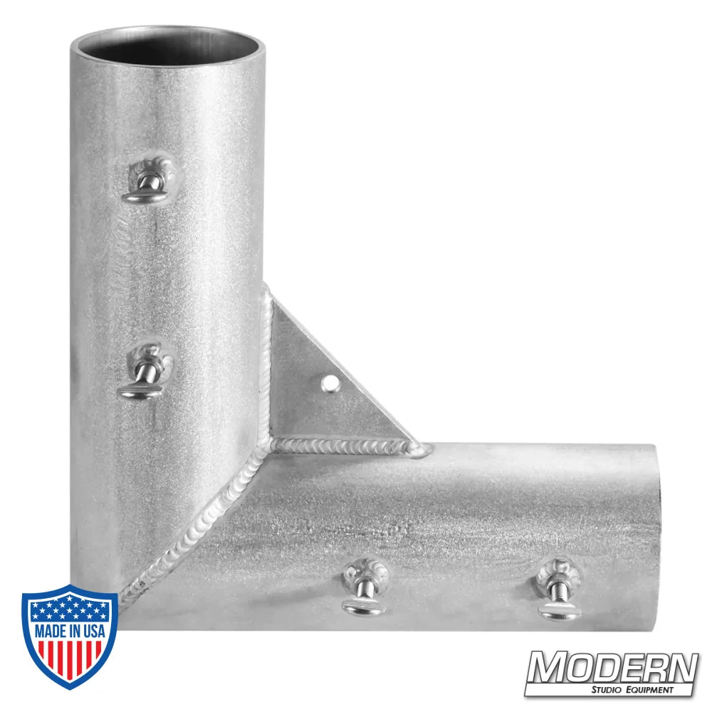 Welded aluminum corner fitting for 4" irrigation pipe, used in film grip rigging setups for creating 90º frame angles.