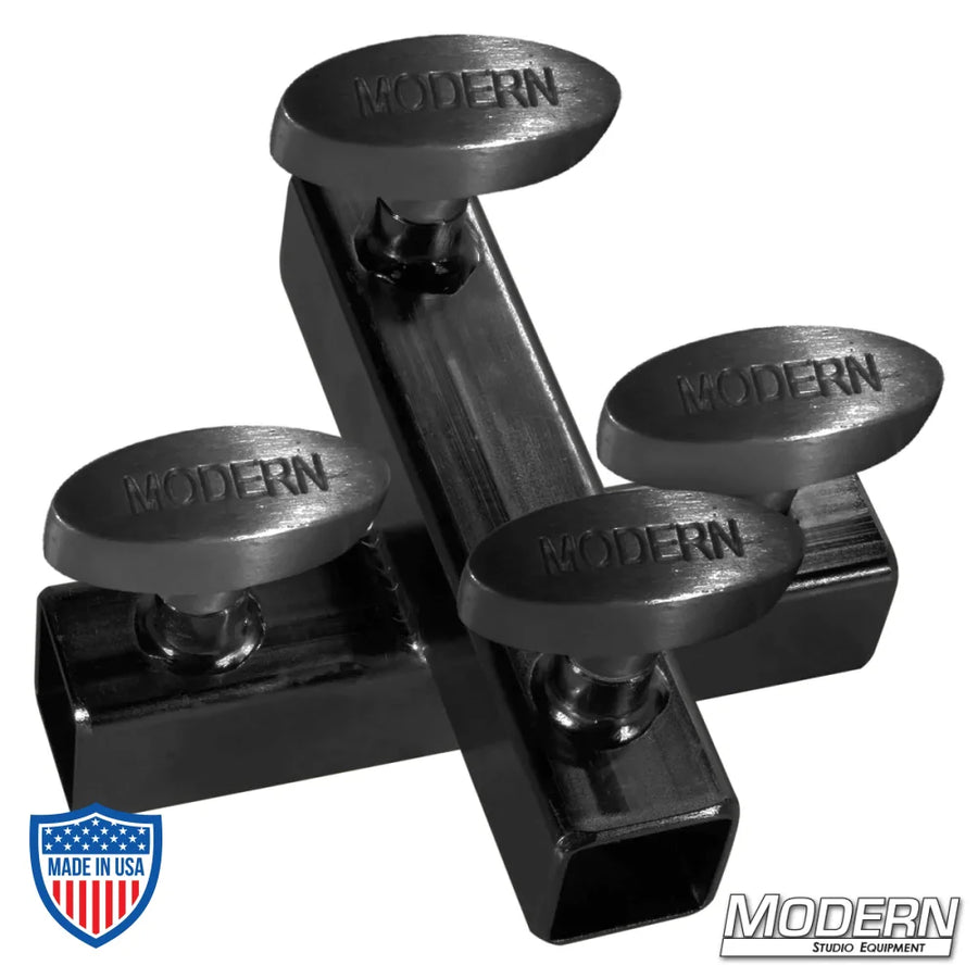 Black zinc cross fitting for 1" square tube with T-handles, used for 90º aluminum connections in film grip rigging.