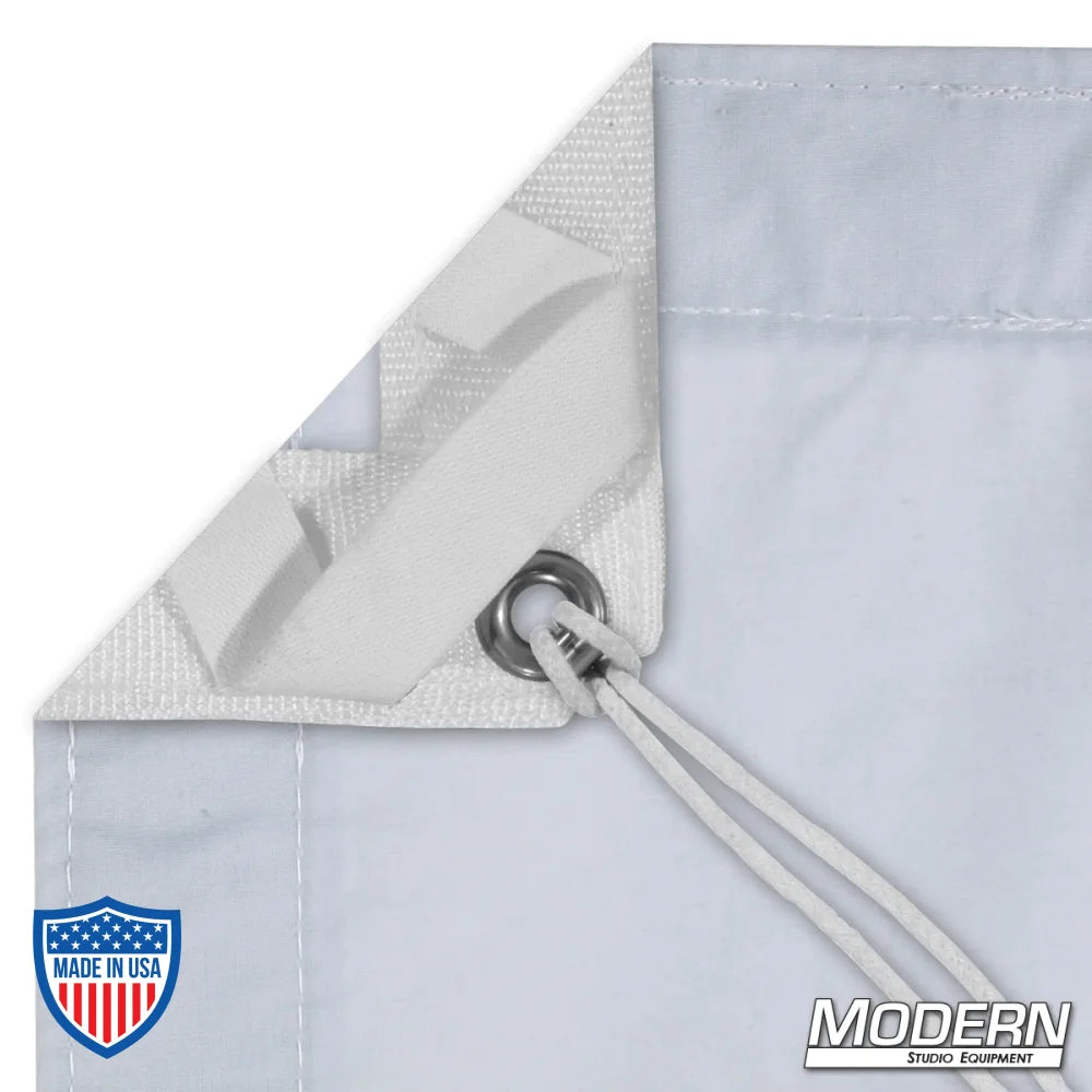 Close-up of Day Blue Muslin slip with elastic corners, grommets, and ties for film rigging, Modern Studio Equipment logo in the corner.