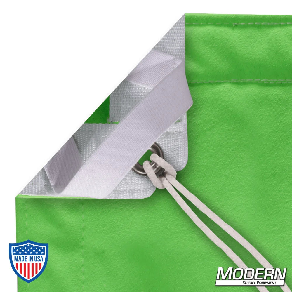 Close-up of lime green digital green screen with webbing, grommets, and ties in corner for film rigging and grip use.