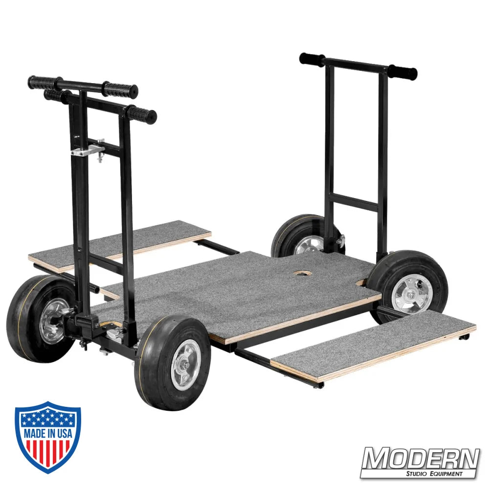 Doorway dolly with 4-way steering and black zinc finish, featuring a wood platform, push and pull bars, for film grip and rigging.