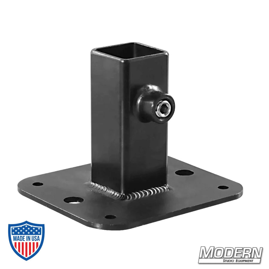 Black zinc flange base for 1" square tube with set screws, used in film grip and rigging to add strength and support to frames.
