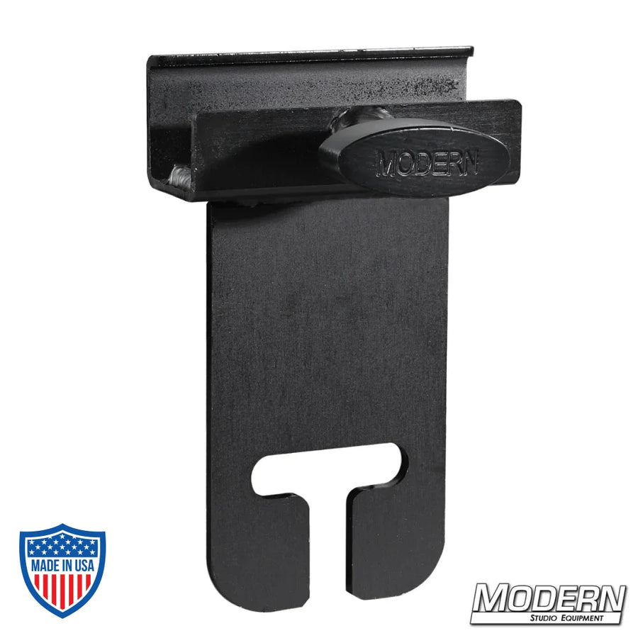 Black zinc flip flop ear clamp for 1" square tube used in film grip rigging setup.