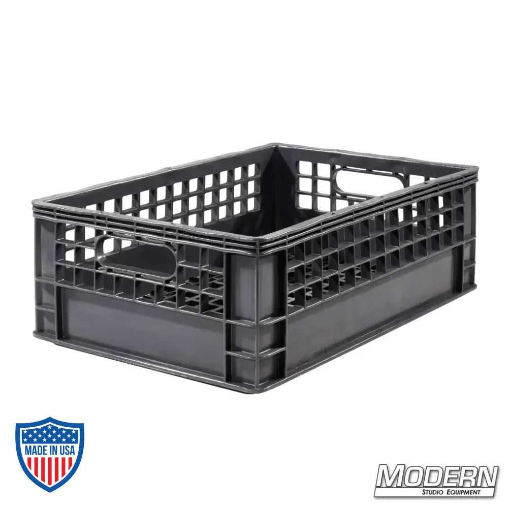 Industry grade plastic half milk crate for film grip and rigging, 19" x 13" x 6.5", stackable with a clean grid bottom.