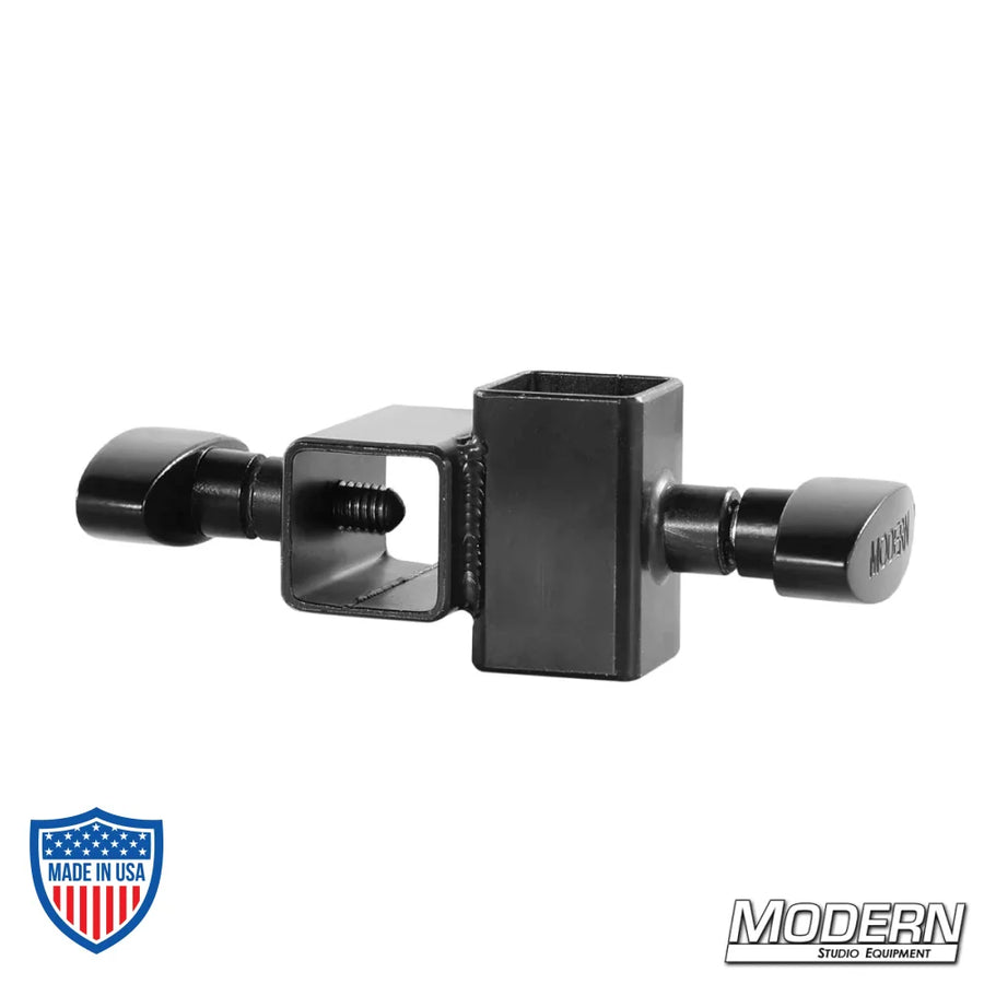 Mini Cross fitting for 1" square tube in black zinc with T-handles for film grip rigging, used to connect aluminum at 90-degree angle.