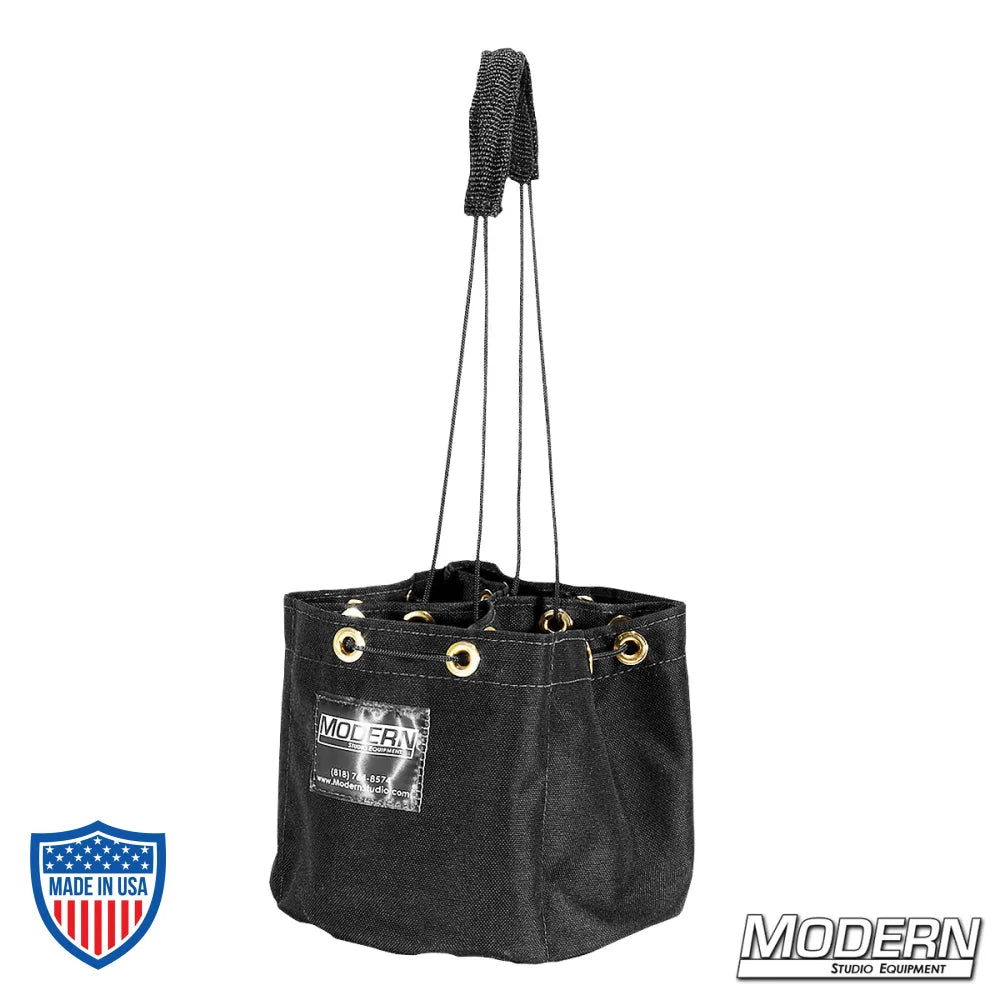Black cordura nail and screw bag with four pockets and grommets, ideal for film grips and rigging professionals.