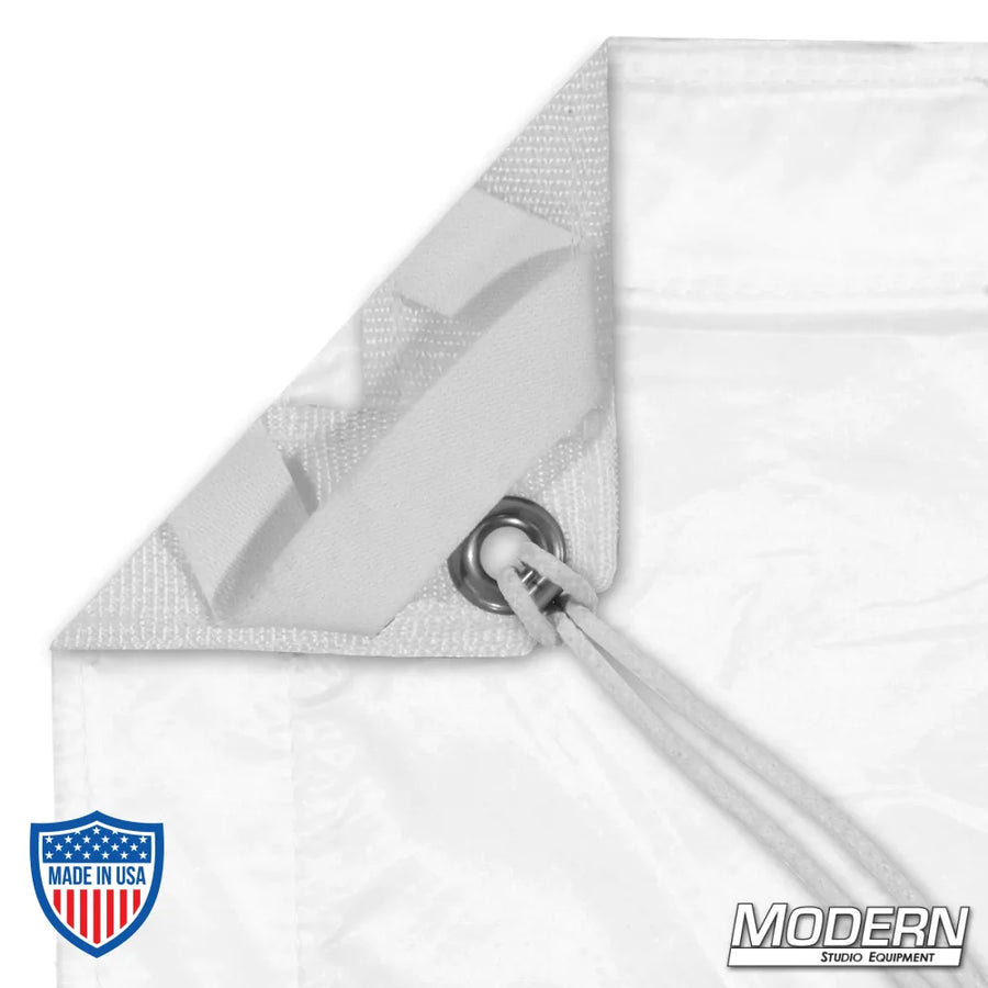 Close-up view of Silent 1/2 Grid Cloth with grommet and tie, featuring webbing along the edges, used in film grip rigging.