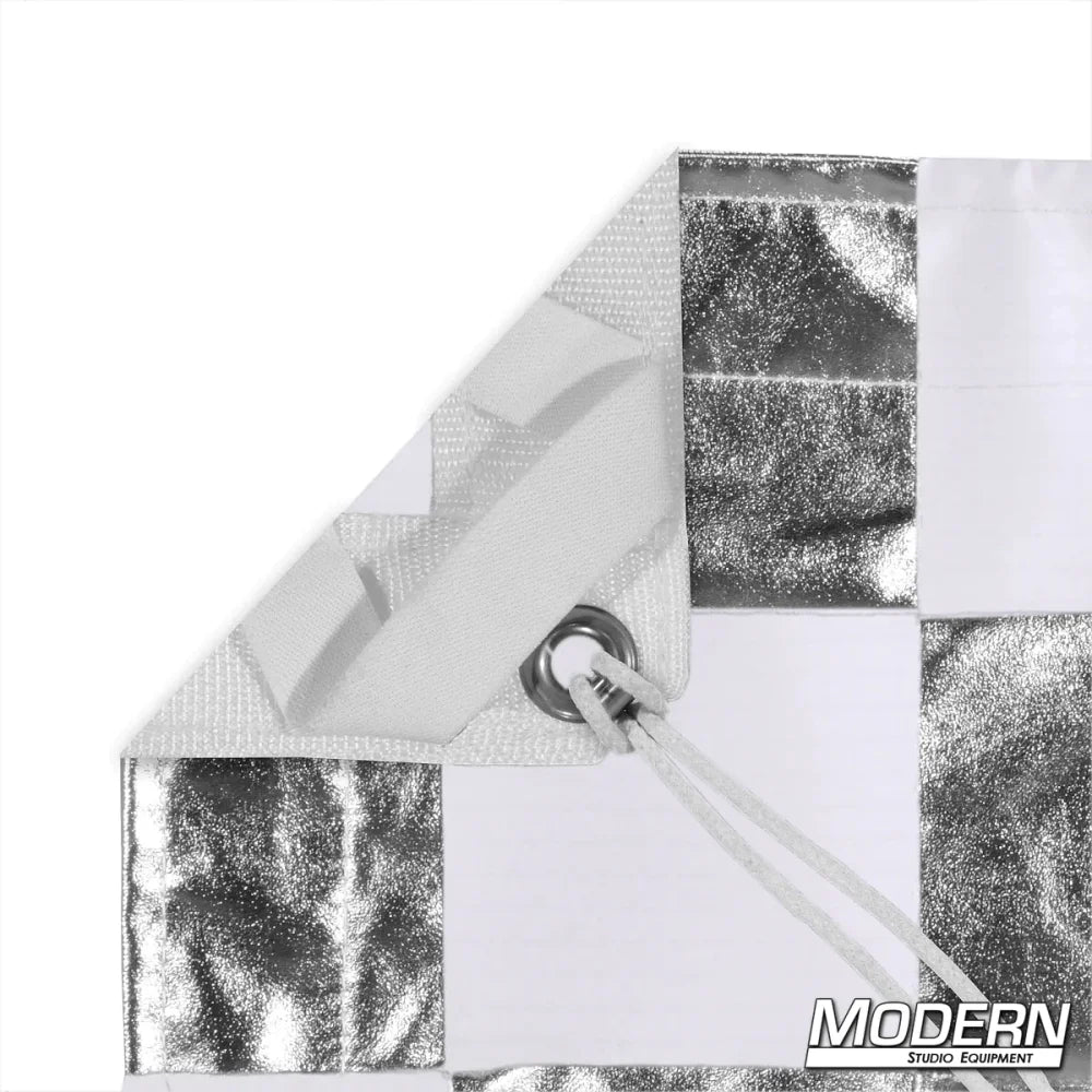 Silver and white checker pattern textile with grommet and ties for film grip rigging, featuring Modern Studio Equipment logo.