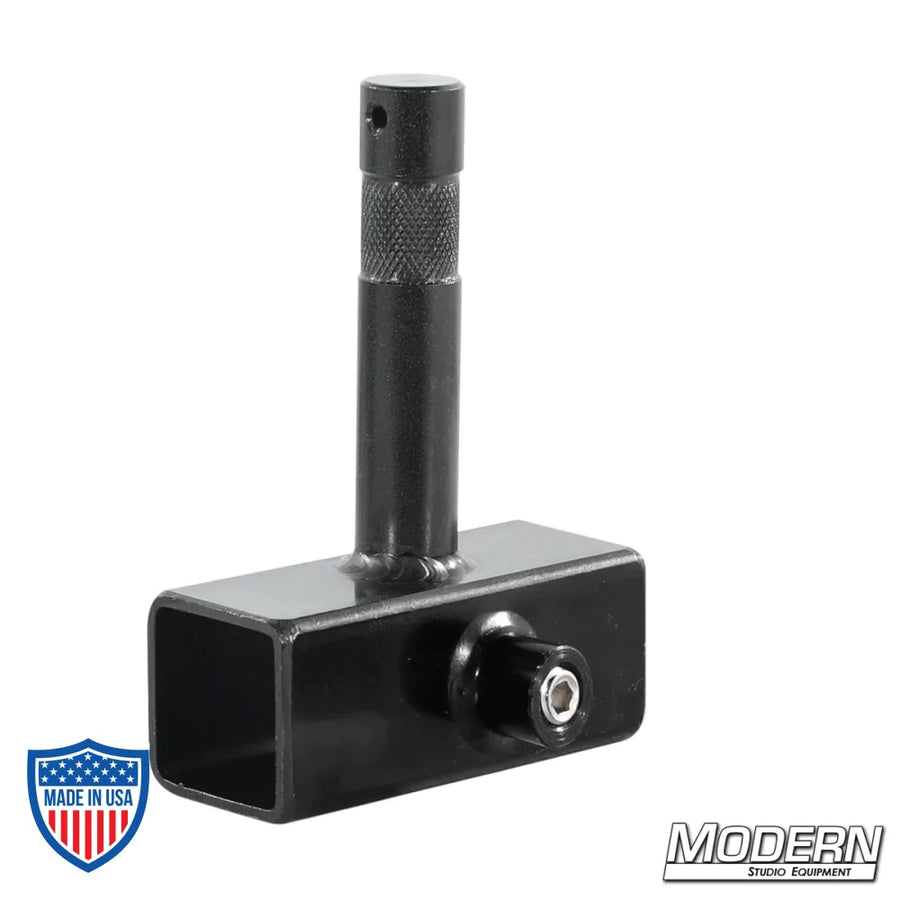 Black zinc slider with baby pin and set screws for 1" square tube used in film grip rigging.