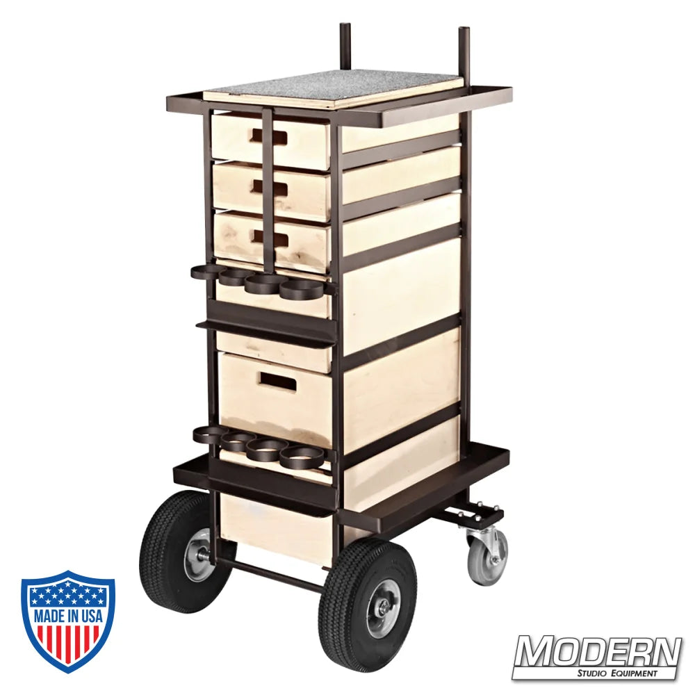 Steel grip cart for film rigging with 3 small and 3 large wooden drawers, fixed rear casters, and front swiveling, braked casters.
