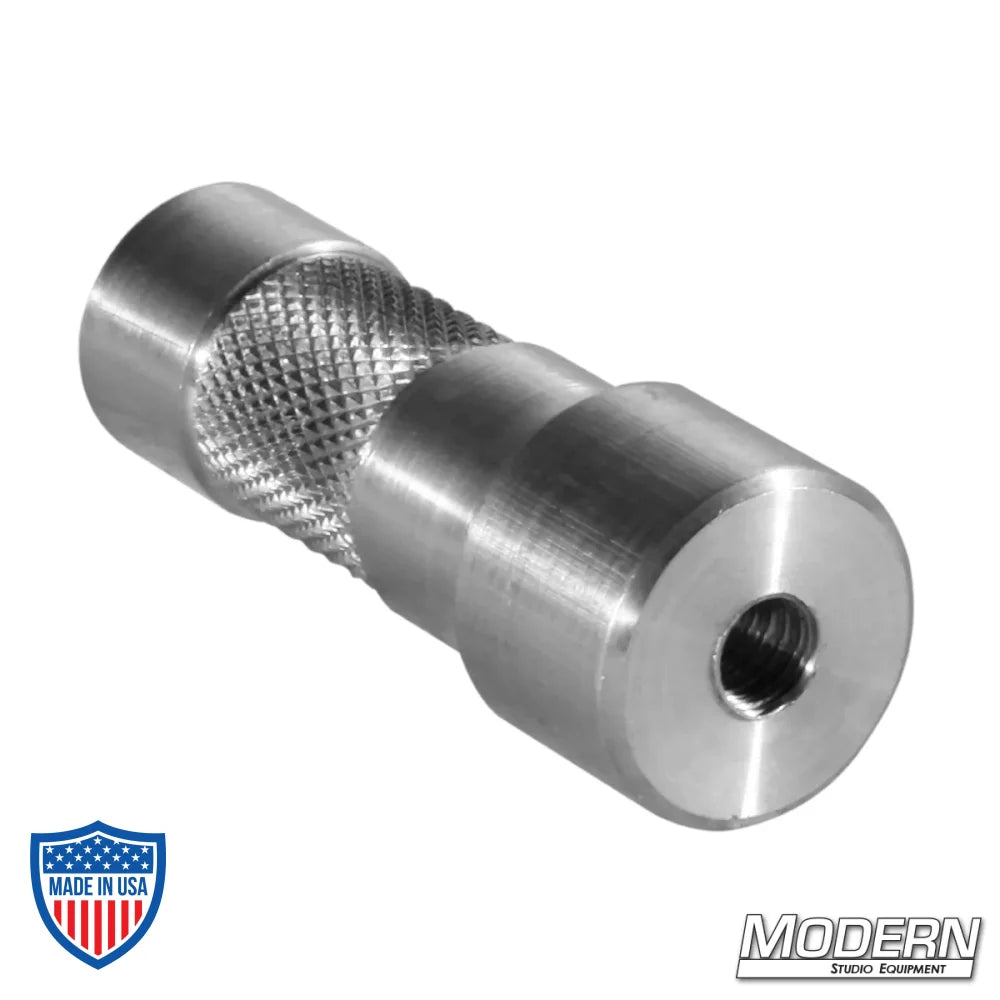 Aluminum starter pin with dual 1/4" female threads for film grip and rigging uses.