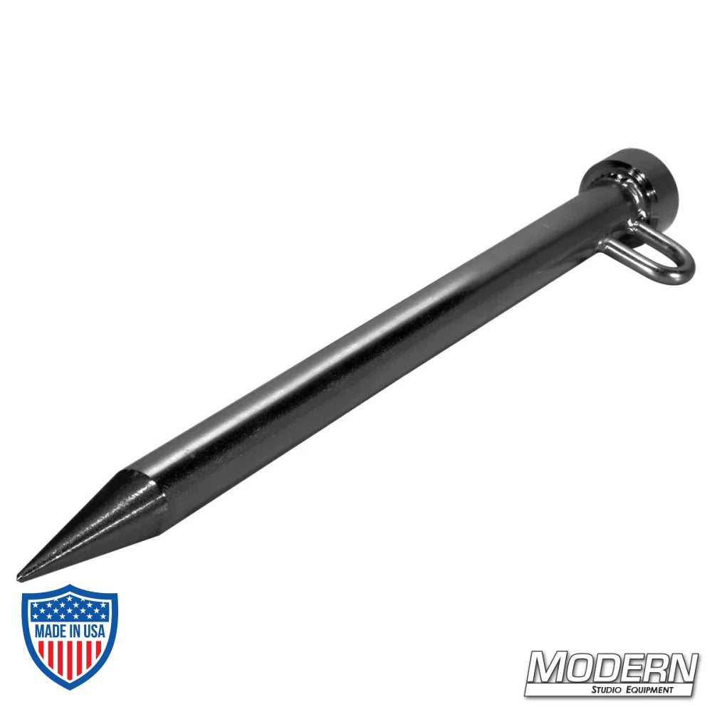 Black zinc tent stake with 1-1/4" diameter steel and d-ring for film grip rigging.