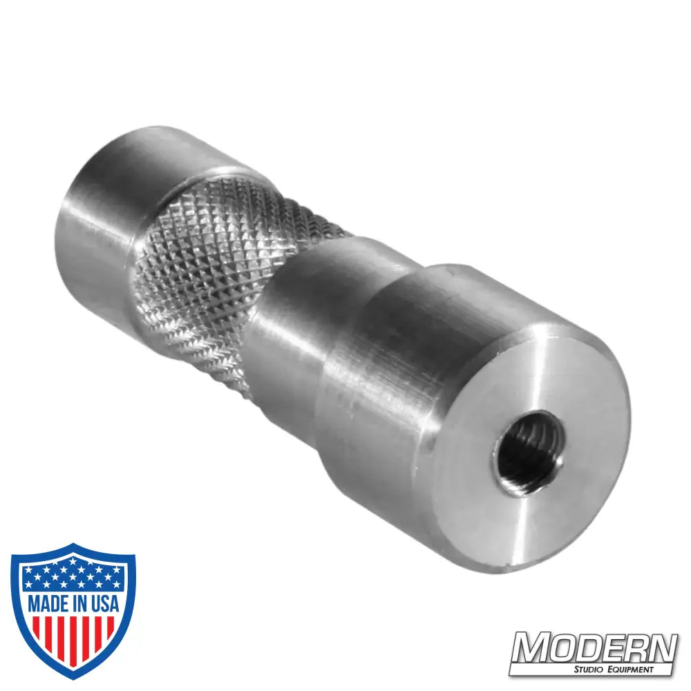 Aluminum starter pin with dual 1/4" female threads for film grip and rigging uses.