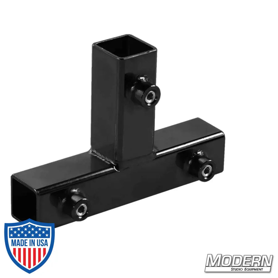 Black zinc tee for 1-inch square tube with set screws, enhancing strength for film grip and rigging on aluminum frames.