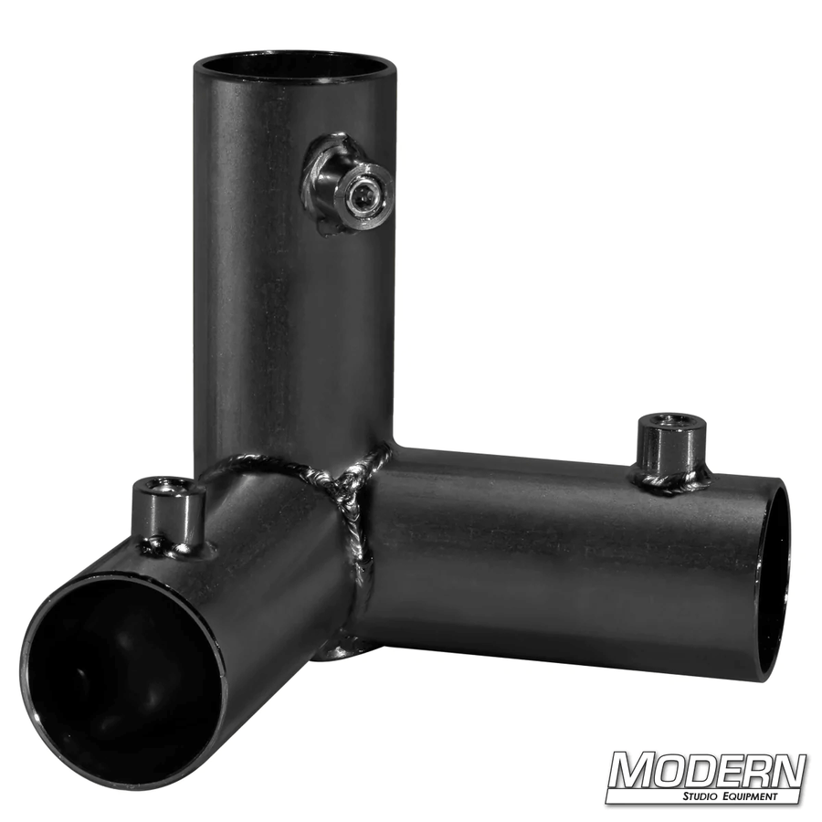 Black zinc 3-way pass through corner fitting for 1-1/4-inch Speed-Rail® with set screws used in film grip rigging.