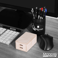 Micro Apple Box on a desk with keyboard, mouse, and pen holder, ideal for film grip and rigging setups.